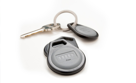 a key ring with a car key and an access control fob on it